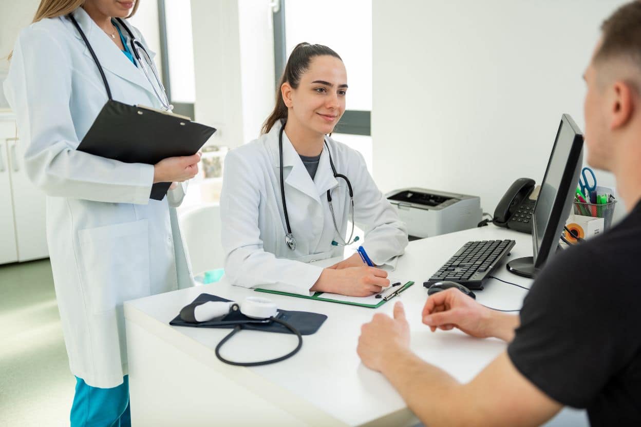 Client consultation with medical practitioner discussing fat reduction treatment options in a modern clinic